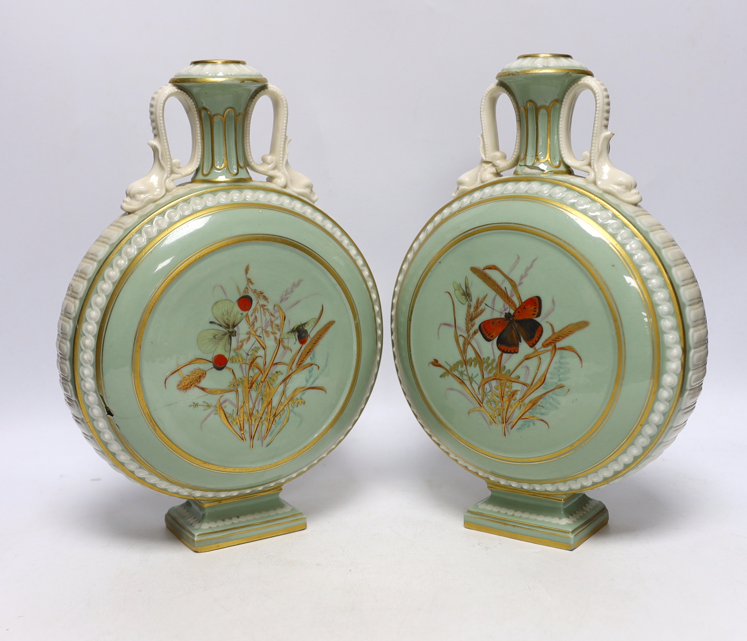 A pair of 19th century Continental moonflasks, decorated in relief and hand painted with butterflies, 28cm high